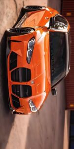 BMW car wallpaper in dramatic sunset sky